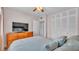 Cozy bedroom features wood dresser and large closet with an open doorway at 1600 W Lake Parker Dr # A2, Lakeland, FL 33805