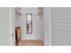 Bright walk-in closet with mirror, shelving, and hardwood flooring at 1600 W Lake Parker Dr # A2, Lakeland, FL 33805