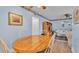 Bright dining area features a wooden table and views into the living room at 1600 W Lake Parker Dr # A2, Lakeland, FL 33805