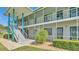 Bright condo building with blue accents and well-maintained landscaping at 1600 W Lake Parker Dr # A2, Lakeland, FL 33805