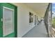 Outdoor hallway featuring a green door, window, and a view of the outdoors at 1600 W Lake Parker Dr # A2, Lakeland, FL 33805