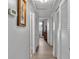 Hallway with laminate floors and multiple storage closets at 1600 W Lake Parker Dr # A2, Lakeland, FL 33805