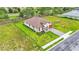 An aerial view showcasing the beautiful home and its expansive lawn within a well-manicured neighborhood at 574 Loblolly Pl, Auburndale, FL 33823