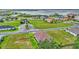 Aerial view of the house in its neighborhood; a lake and other homes can be seen in the distance at 574 Loblolly Pl, Auburndale, FL 33823