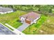 Aerial view of a nicely landscaped home, showing roof, driveway, and grassy lawns with dark fence at 574 Loblolly Pl, Auburndale, FL 33823