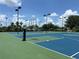 Well-lit basketball court with manicured landscaping, nestled in a residential community on a sunny day at 574 Loblolly Pl, Auburndale, FL 33823