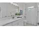 Bright bathroom with white vanity, white subway tile shower and tub with updated fixtures at 574 Loblolly Pl, Auburndale, FL 33823