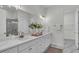 Bright bathroom with double vanity, marble floors, and a large mirror at 574 Loblolly Pl, Auburndale, FL 33823