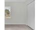 A small bedroom with light floors, a window, and a large closet at 574 Loblolly Pl, Auburndale, FL 33823