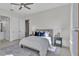 Stylishly staged bedroom featuring a ceiling fan, neutral color palette, and contemporary decor at 574 Loblolly Pl, Auburndale, FL 33823