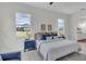 A bedroom featuring a large bed, bedside tables, and a view of the outdoors at 574 Loblolly Pl, Auburndale, FL 33823