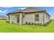 The home features a neutral stucco exterior, complemented by brown trim and a well-maintained lawn and landscape at 574 Loblolly Pl, Auburndale, FL 33823