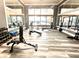 The fitness center features modern equipment, ample natural light, and mirrors for a complete workout experience at 574 Loblolly Pl, Auburndale, FL 33823