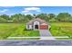 Charming single-story home featuring a tile roof, wood-look garage door, and well-maintained landscaping at 574 Loblolly Pl, Auburndale, FL 33823