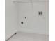 Bright laundry room with white walls, wire shelving and hookups for a washer and dryer at 574 Loblolly Pl, Auburndale, FL 33823