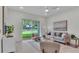 Cozy living room with neutral decor, stylish furniture, and a view of the backyard at 574 Loblolly Pl, Auburndale, FL 33823