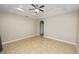 This bedroom has a tray ceiling, ceiling fan, tiled floor, and neutral paint at 808 James Way, Lake Alfred, FL 33850