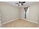 Cozy bedroom with a ceiling fan, tile floors, and natural light from the window at 808 James Way, Lake Alfred, FL 33850