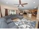 Spacious living room with sectional sofa and large TV at 808 James Way, Lake Alfred, FL 33850