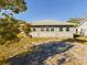 Tan house exterior with large windows and grassy yard at 200 Holland Street, Lake Wales, FL 33859