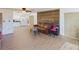 Living room with brown couch, wood wall, and kitchen view at 200 Holland Street, Lake Wales, FL 33859