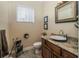 Charming powder room with granite countertop, decorative mirror, and modern fixtures at 7330 Reflections Lake Dr, Lakeland, FL 33813