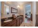 Elegant bathroom with double sinks, granite countertops, and a view into the Primary bedroom at 7330 Reflections Lake Dr, Lakeland, FL 33813
