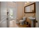 Cozy bathroom with access to the backyard, a pedestal sink, and traditional fixtures at 7330 Reflections Lake Dr, Lakeland, FL 33813