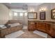 Large bathroom featuring a soaking tub, walk-in shower, and dual vanities with granite countertops at 7330 Reflections Lake Dr, Lakeland, FL 33813