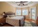 Comfortable bedroom with trey ceiling, hardwood floors, and a view of the backyard at 7330 Reflections Lake Dr, Lakeland, FL 33813