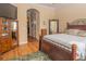 Bedroom with a queen-sized bed, hardwood floors, and plenty of natural light at 7330 Reflections Lake Dr, Lakeland, FL 33813
