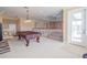 Bonus room overlooking the home's interior, featuring a pool table and access to the second-story balcony at 7330 Reflections Lake Dr, Lakeland, FL 33813