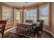 Cozy dining area with large windows, a view of the golf course, and stylish decor at 7330 Reflections Lake Dr, Lakeland, FL 33813