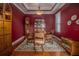 Elegant dining room with red walls, wood floors, and a large china cabinet at 7330 Reflections Lake Dr, Lakeland, FL 33813