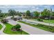 Elegant community entrance featuring well-manicured landscaping, decorative fountains, and an American flag at 7330 Reflections Lake Dr, Lakeland, FL 33813