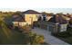 Beautiful home featuring an attached three-car garage and a well-manicured lawn at 7330 Reflections Lake Dr, Lakeland, FL 33813