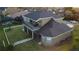 Aerial view of home featuring a large outdoor patio, screened-in lanai, spacious yard, and well-maintained landscaping at 7330 Reflections Lake Dr, Lakeland, FL 33813
