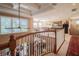 Upstairs hallway overlooking the lower level with coffered ceilings and beautiful natural light at 7330 Reflections Lake Dr, Lakeland, FL 33813