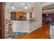An open kitchen features a breakfast bar, granite countertops, and wood cabinets at 7330 Reflections Lake Dr, Lakeland, FL 33813