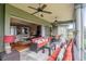 Spacious covered lanai with seating, bar, and a great view connecting to the living room through sliding glass doors at 7330 Reflections Lake Dr, Lakeland, FL 33813