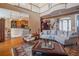 Spacious living room with hardwood floors, a large sofa, and a view of the kitchen at 7330 Reflections Lake Dr, Lakeland, FL 33813