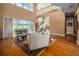 Open-concept living room with hardwood floors, a view of the lanai, and a second-floor balcony at 7330 Reflections Lake Dr, Lakeland, FL 33813