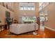 Bright living room with vaulted ceilings, hardwood floors, and a large window overlooking the backyard at 7330 Reflections Lake Dr, Lakeland, FL 33813
