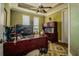 Home office space features a ceiling fan, built-in desk, and plush carpeting at 7330 Reflections Lake Dr, Lakeland, FL 33813