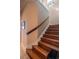Wooden staircase featuring a classic wooden handrail, leading to the upper level of the home at 7330 Reflections Lake Dr, Lakeland, FL 33813