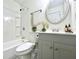 Clean bathroom with a white vanity, a round mirror, and a shower-tub combo at 3523 Colleen Dr, Lakeland, FL 33810