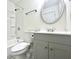 Clean bathroom with a white vanity, a round mirror, and a shower-tub combo at 3523 Colleen Dr, Lakeland, FL 33810