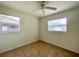 Bedroom with two windows, a ceiling fan, and tile floors at 3523 Colleen Dr, Lakeland, FL 33810