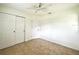 Bright bedroom featuring tile floors, a ceiling fan, and a double door closet at 3523 Colleen Dr, Lakeland, FL 33810
