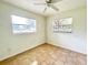 Bedroom with two windows, a ceiling fan, and tile floors at 3523 Colleen Dr, Lakeland, FL 33810